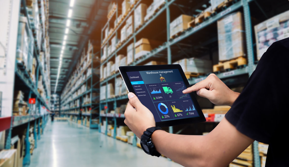 A person holding up a tablet that is displaying charts and graphs