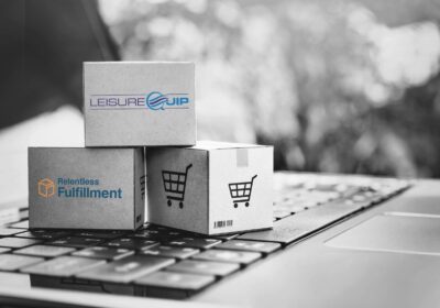 Three small, custom-branded boxes sitting on a laptop keyboard.